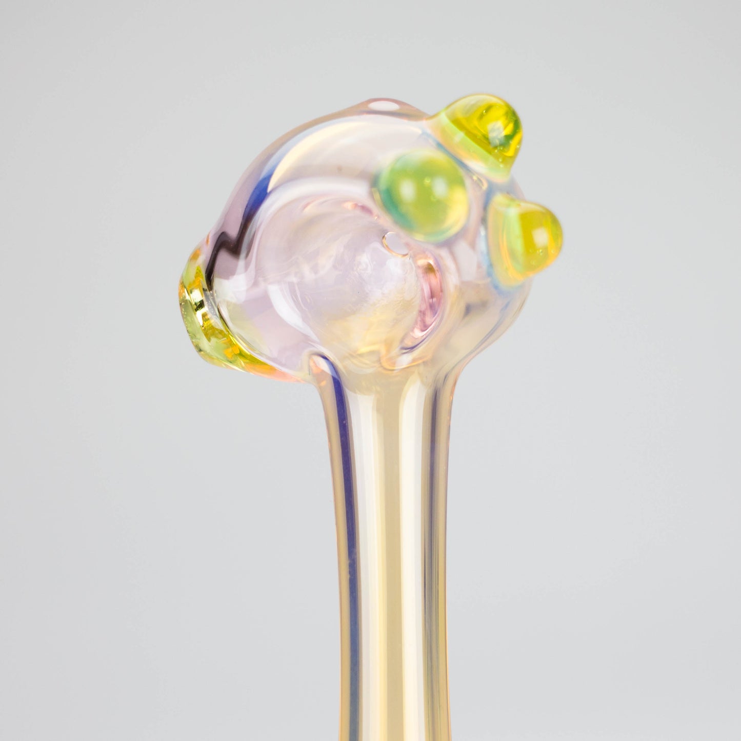 a translucent yellowish smoking pipe close up